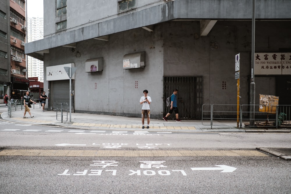 man standing in front of road