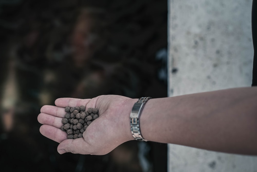 person holding black beads