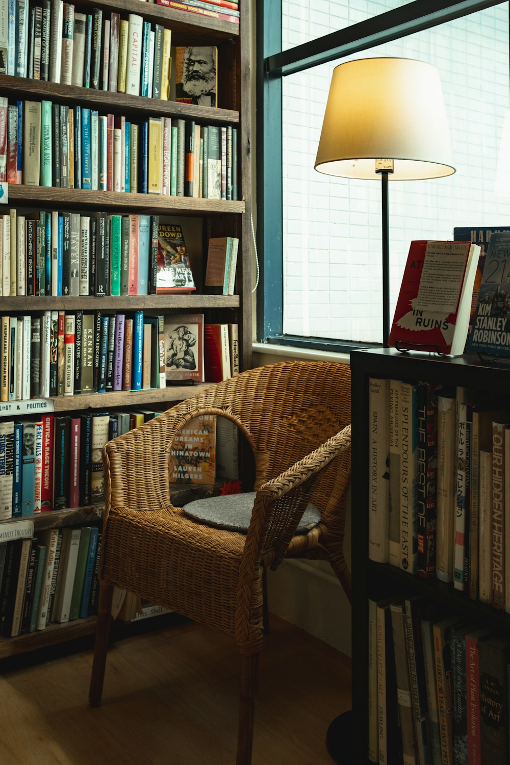 brown wicker chair and books