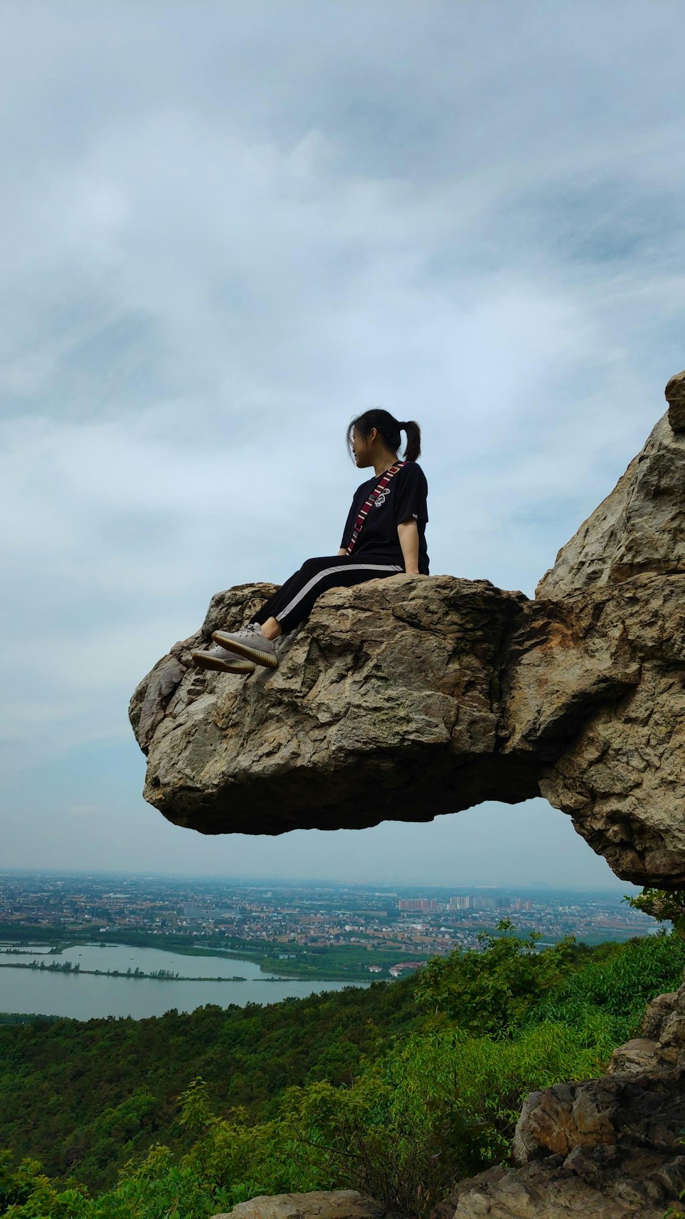 woman sitting on rock formation