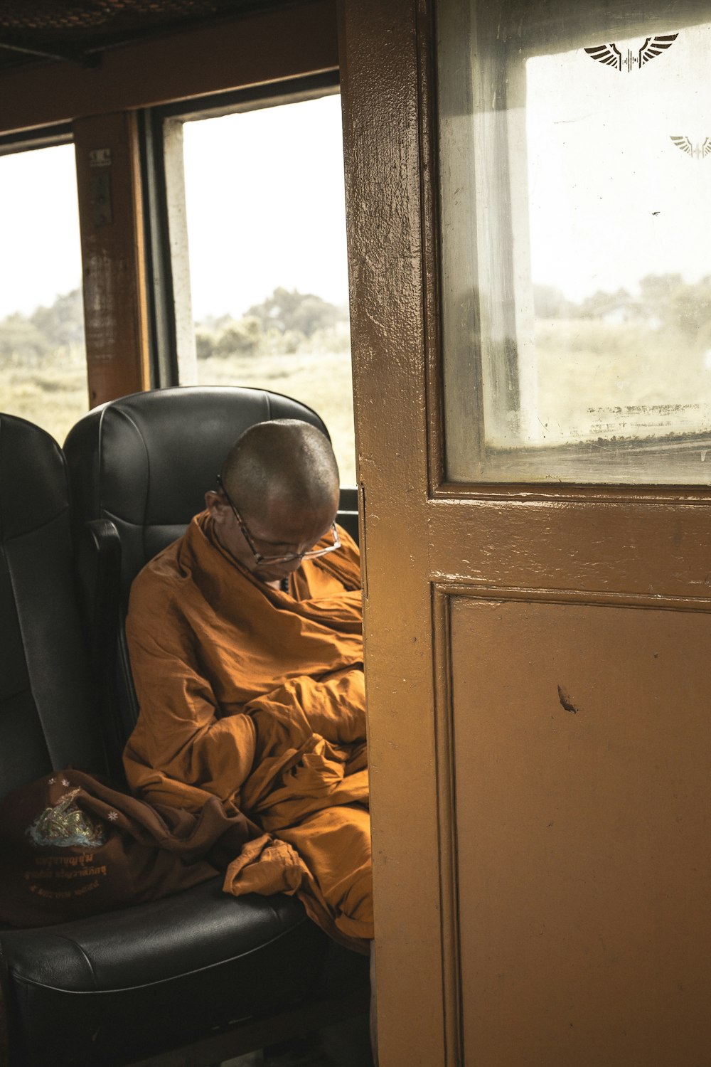 man sitting on black leather vehicle seat