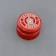 A red bottle cap with 'La Châsse France' printed in white text around a central graphic symbol, displayed against a gray background.