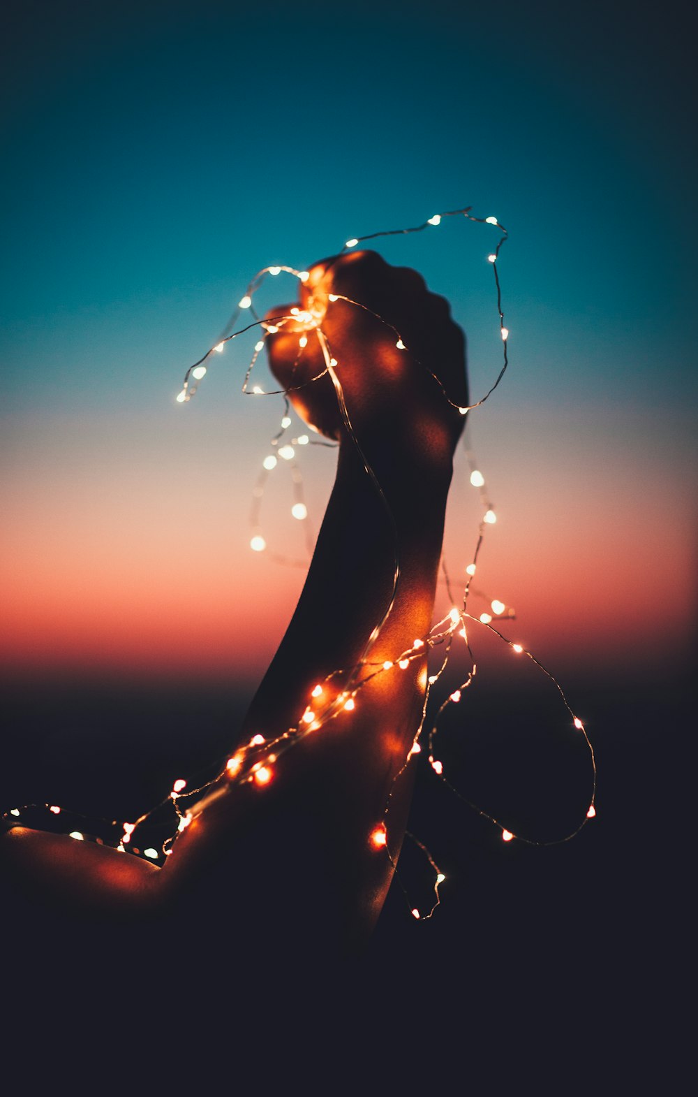 person holding a light close-up photography