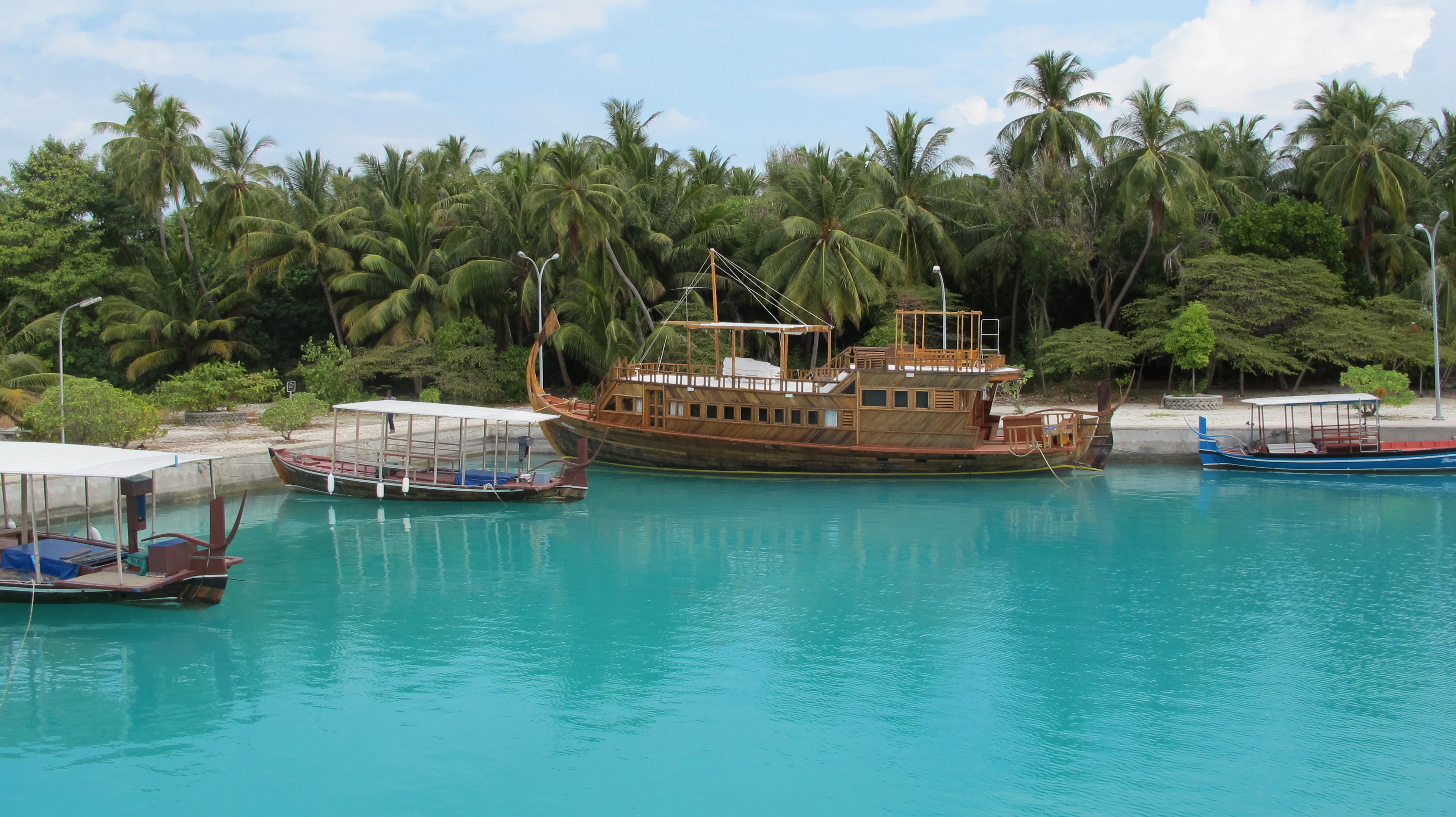 A traditional Maldivian dhoni anchored in an island harbour