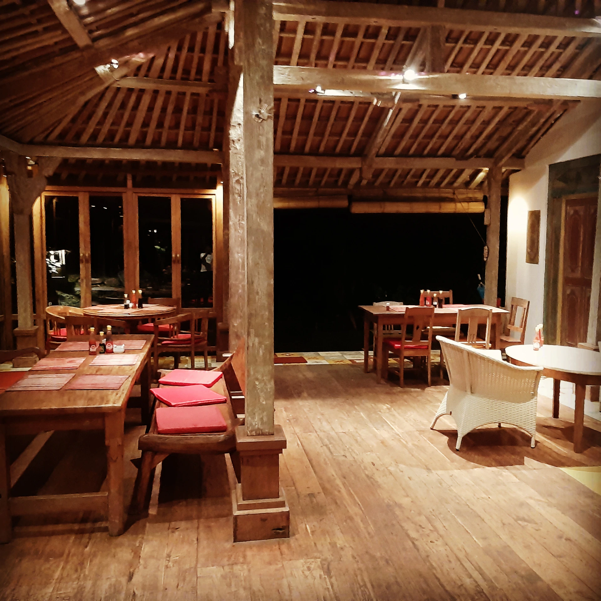 A rustic restaurant setting with wooden tables, fresh local dishes, and a welcoming atmosphere.