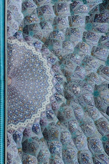 Close-up of delicate Turkish tiles in shades of turquoise and burnt red, showcasing intricate patterns.