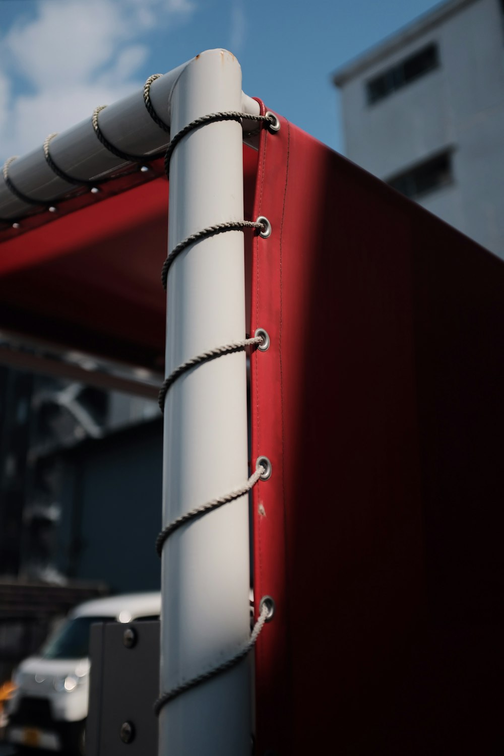 a close up of a red and white metal pole