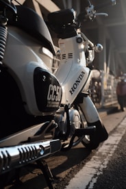 white and black Honda motorcycle