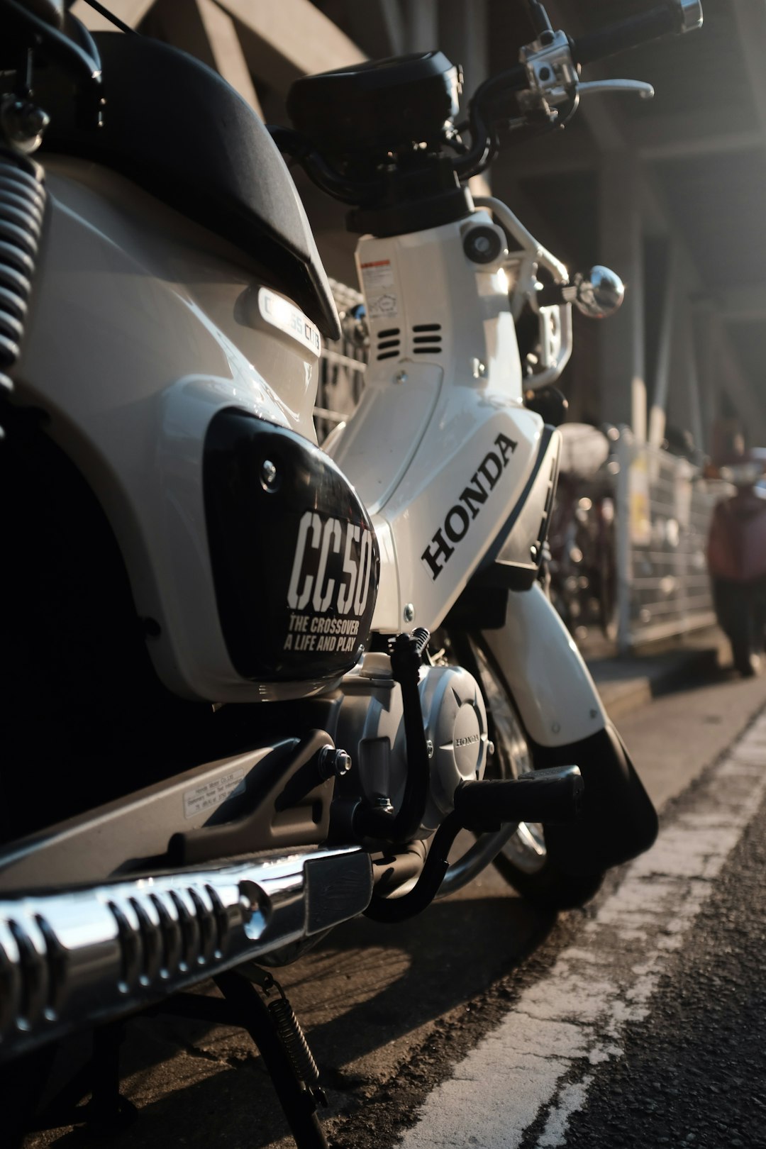 white and black Honda motorcycle