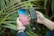 An outdoor scene featuring a person using a wireless power bank while hiking.