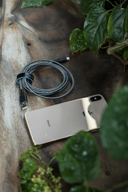 Tangle-free braided cable stretched out beside a glowing smartphone screen.