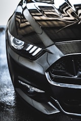 A close-up of a car's polished surface reflecting light.