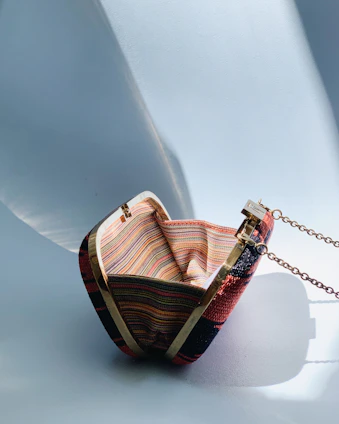 Small handcrafted clutch bag, featuring delicate metal accents and artisanal details