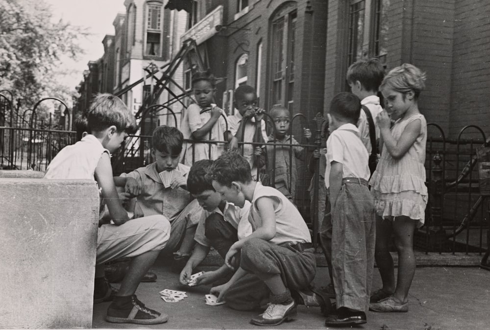 grayscale photography of children near outdoor