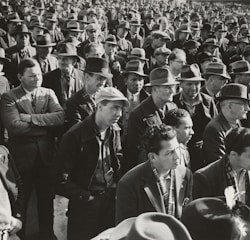 A diverse group of determined men in formal attire standing together, symbolizing leadership and brotherhood.