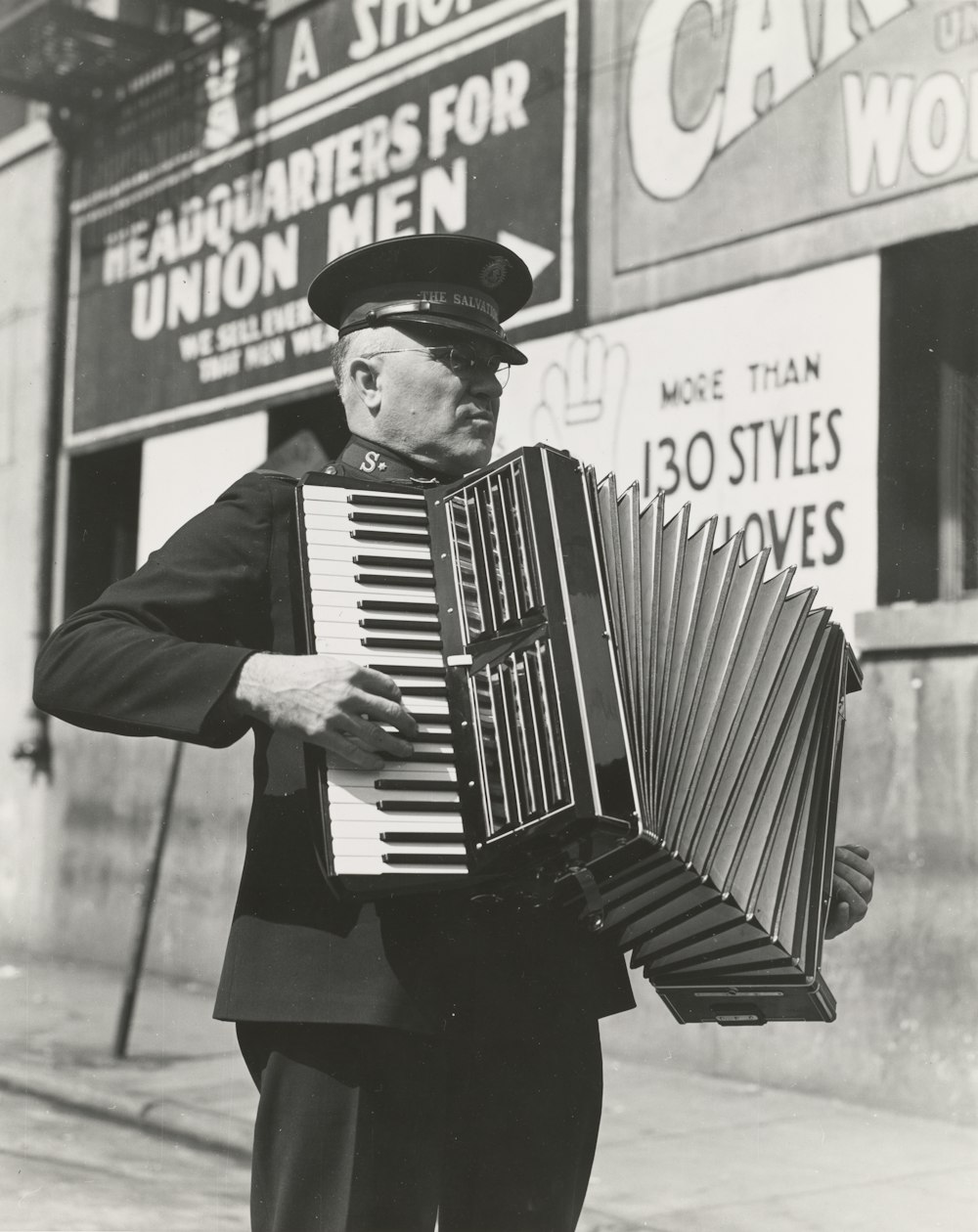 grayscale photo of man playing accordion