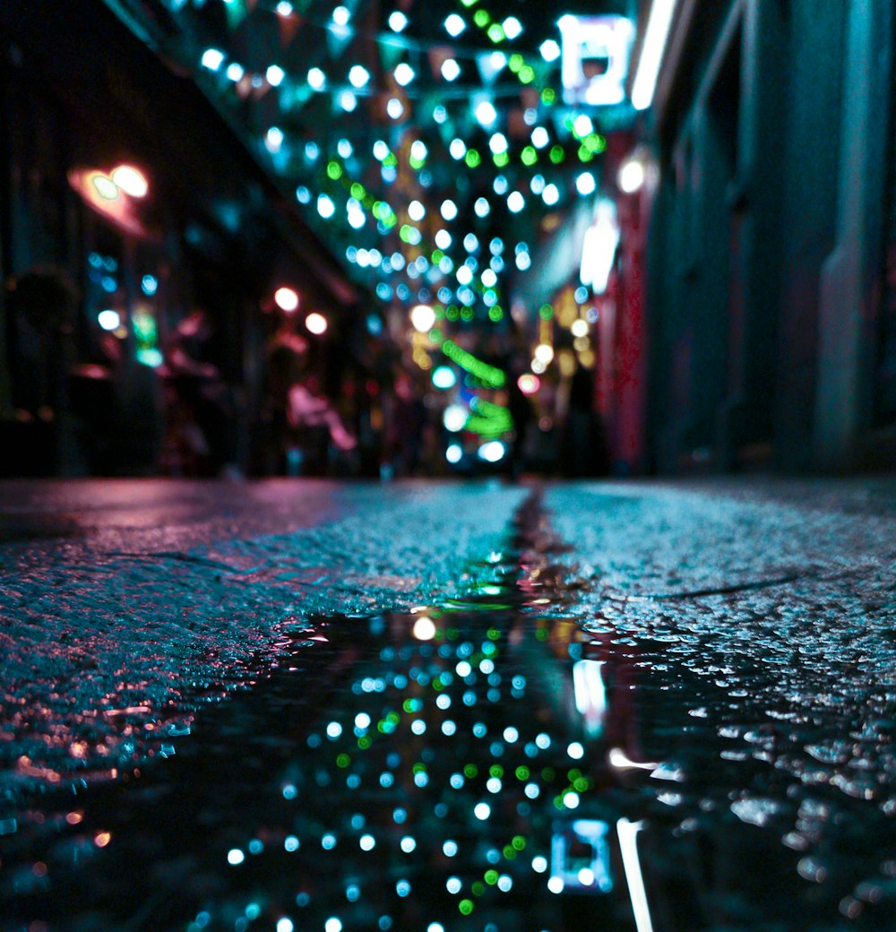 a wet street with a lot of lights on it