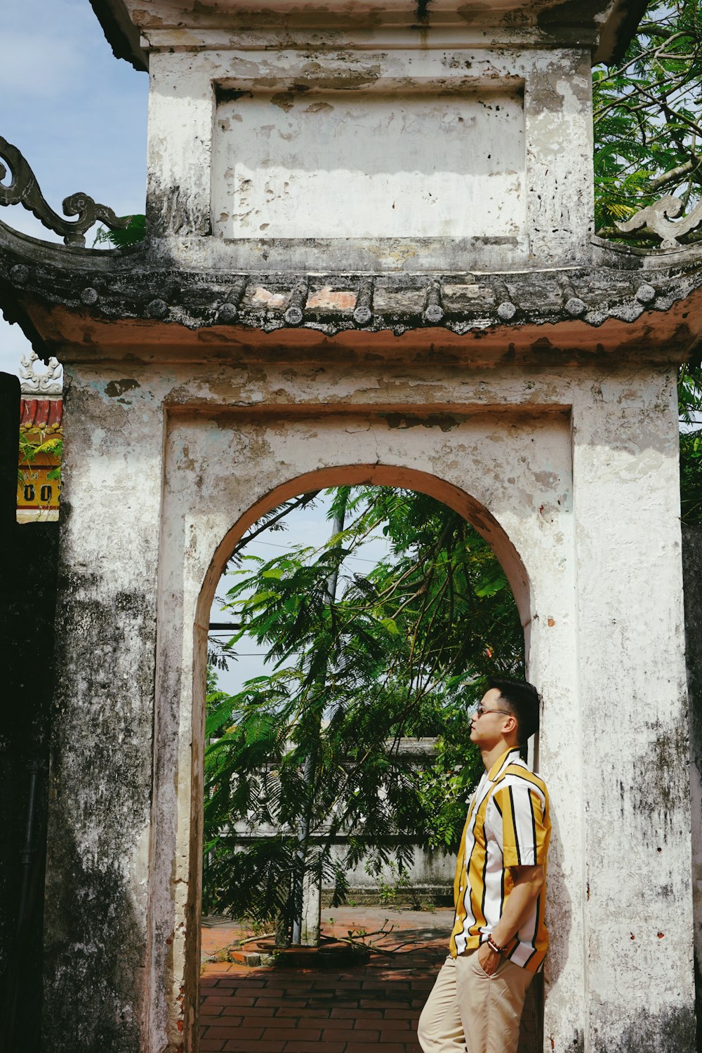 man leaning on arched doorway