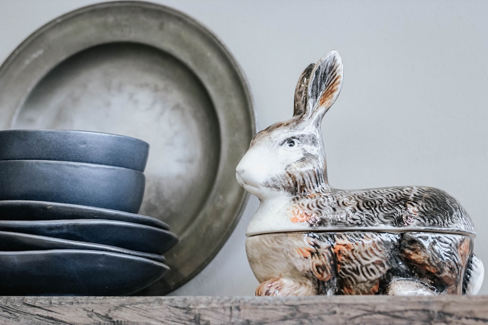 black and white ceramic rabbit figurine near bowls