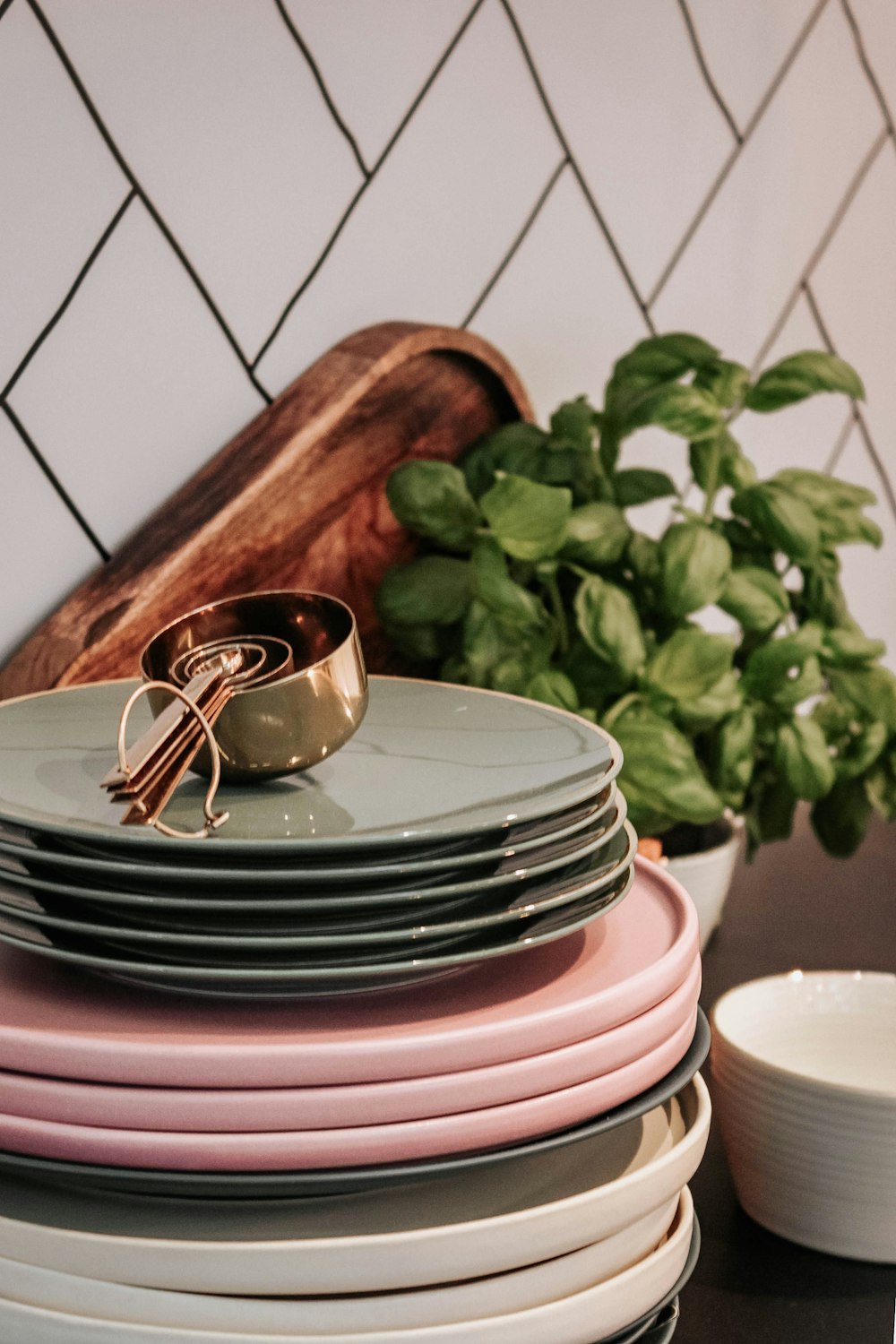 grey measuring spoons on piles of plates