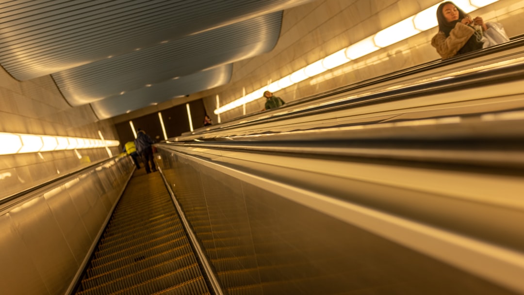 woman riding escalator