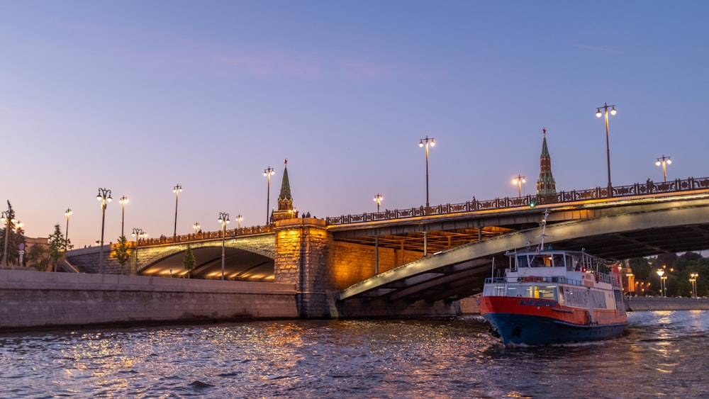 red and black boat at the river during sunset