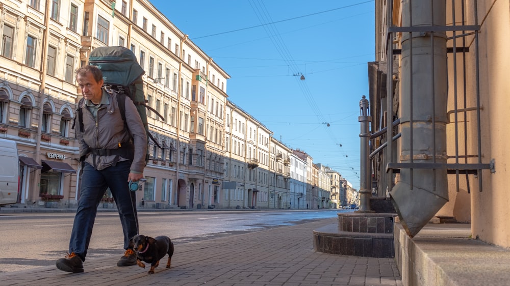 man walking beside dog