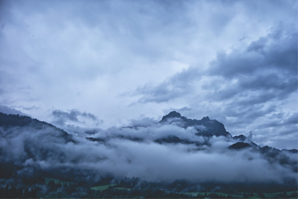 clouds near mountain during daytime