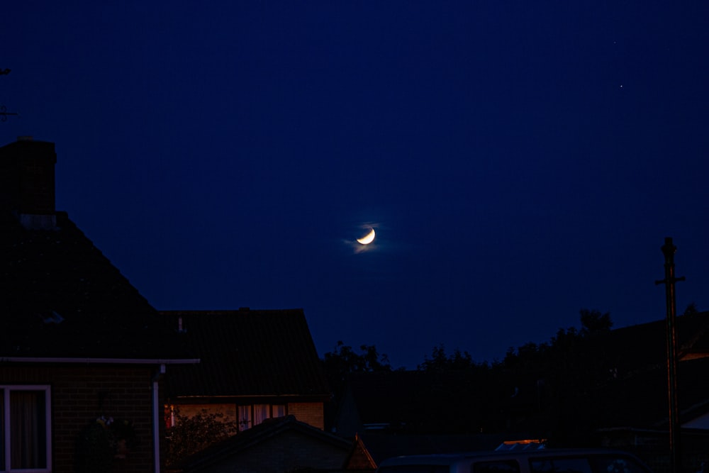 the moon is shining brightly in the night sky