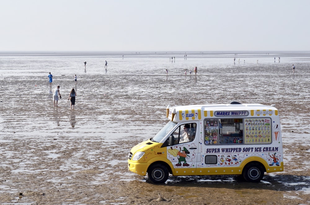 white and yellow soft ice cream van