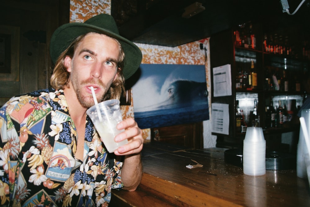 man drinking near table