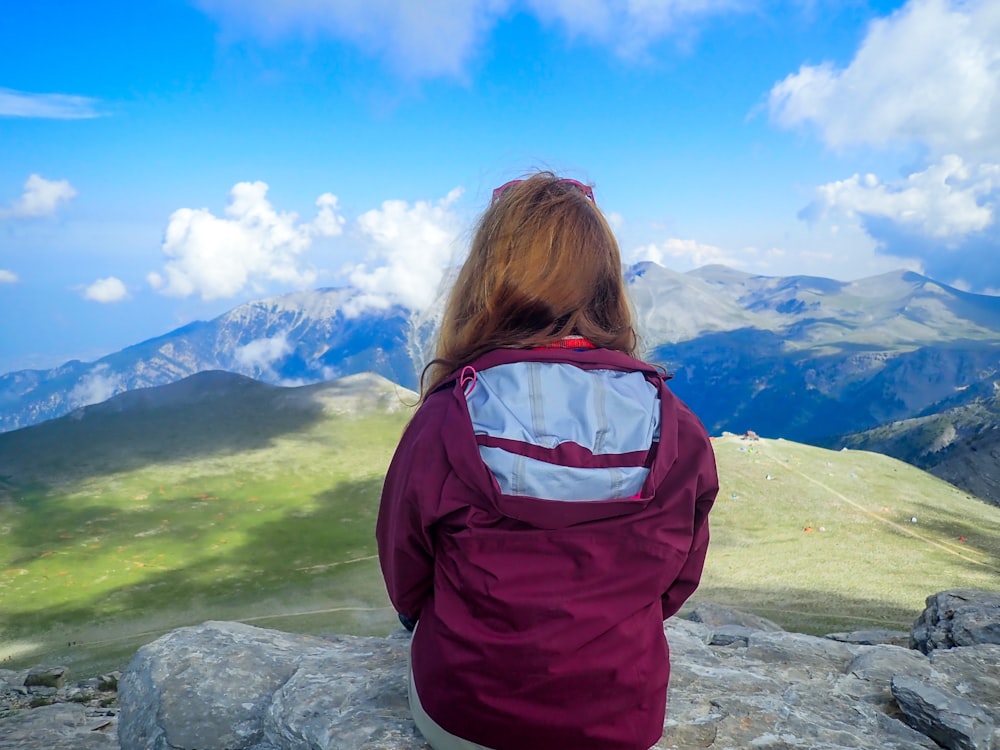 person sitting on rock