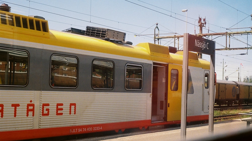 white, yellow, and gray train