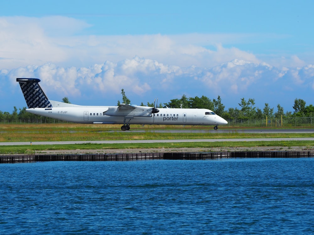 white plane near body of water