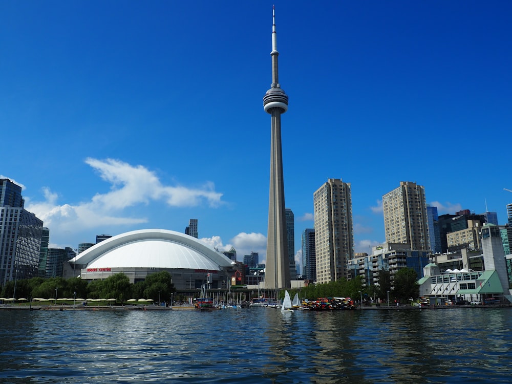 grey concrete buildings near body of water during daytime