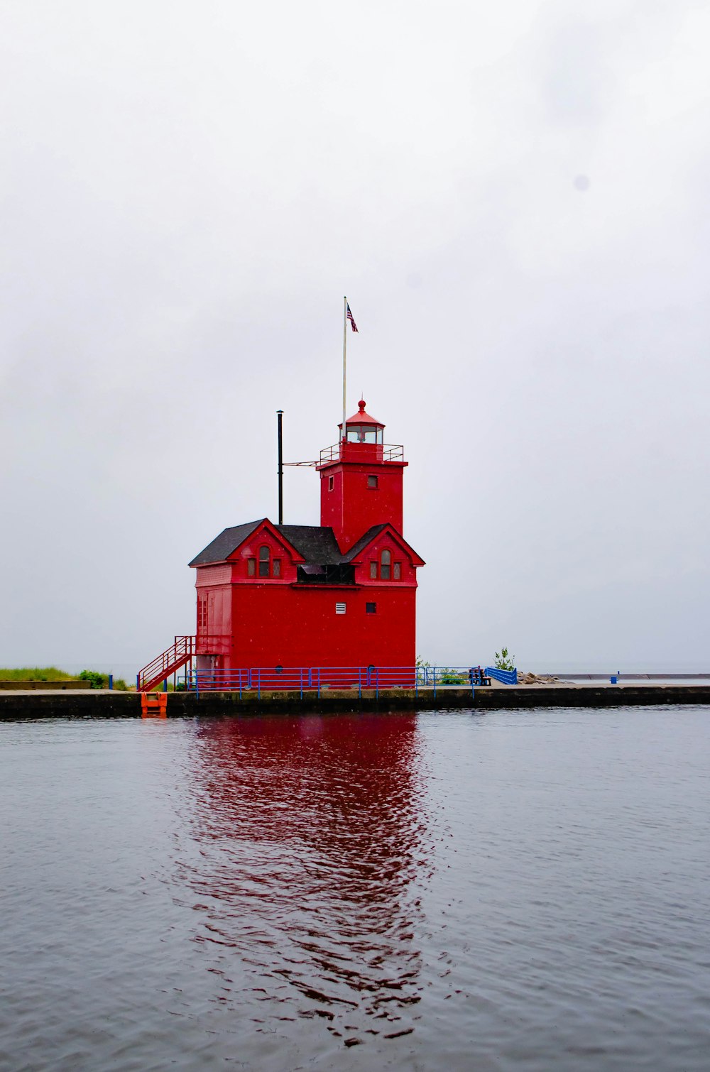 red house near body of water