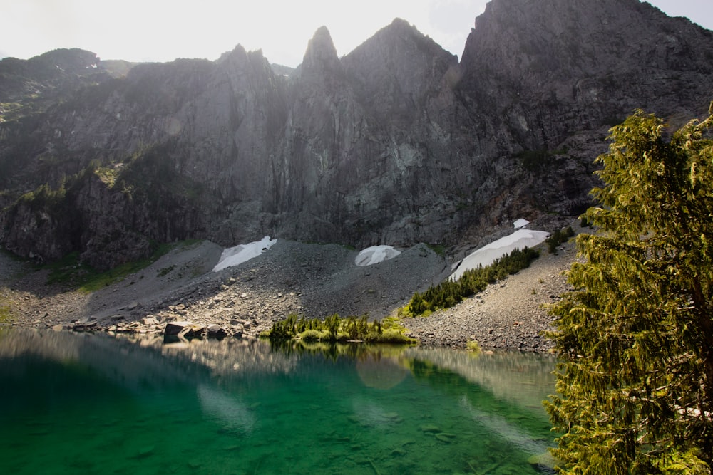 hill near body of water during daytime