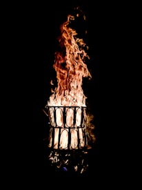 Close-up of a stylish fire vase with flickering flames inside, highlighting its elegant design.