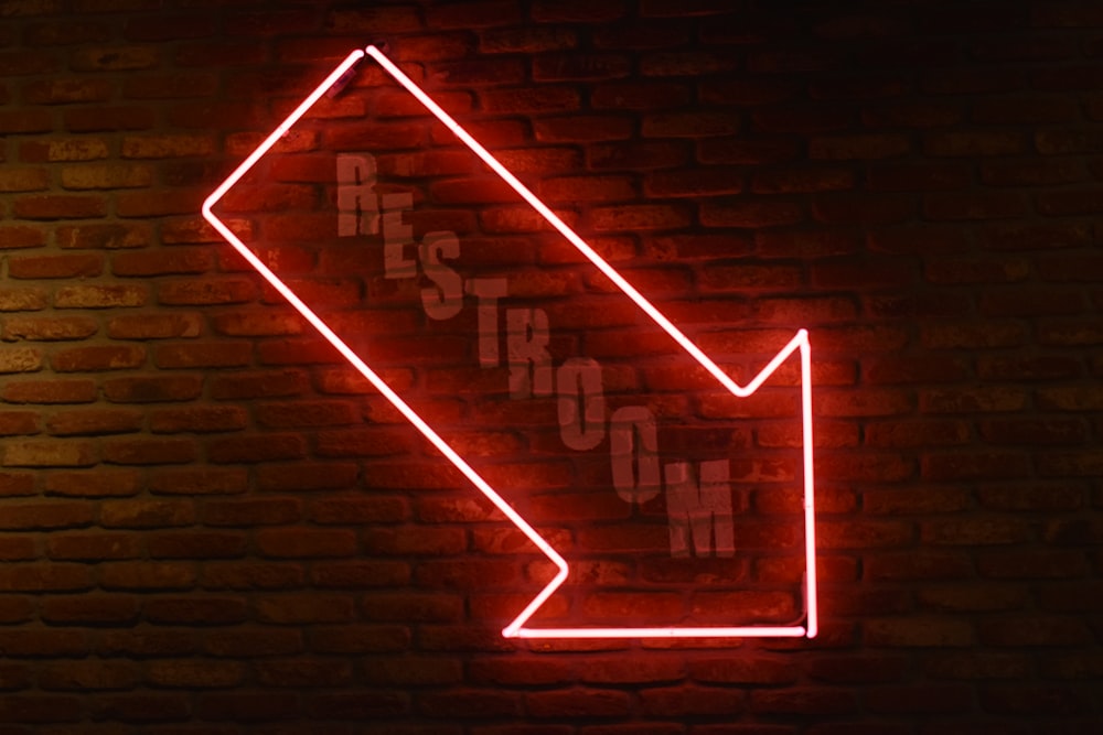 red arrow neon signage