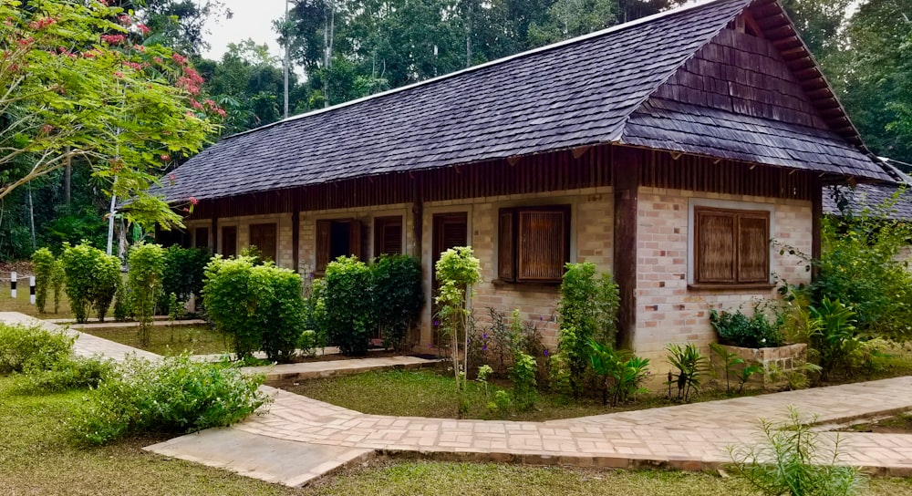 white and brown concrete house near trees at daytime