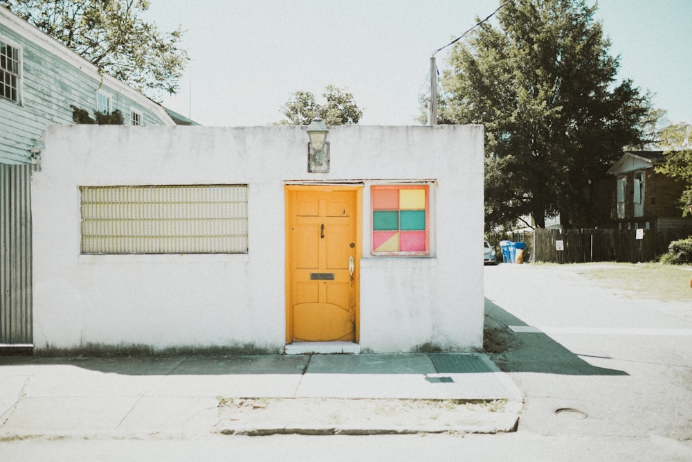 white concrete house near tree