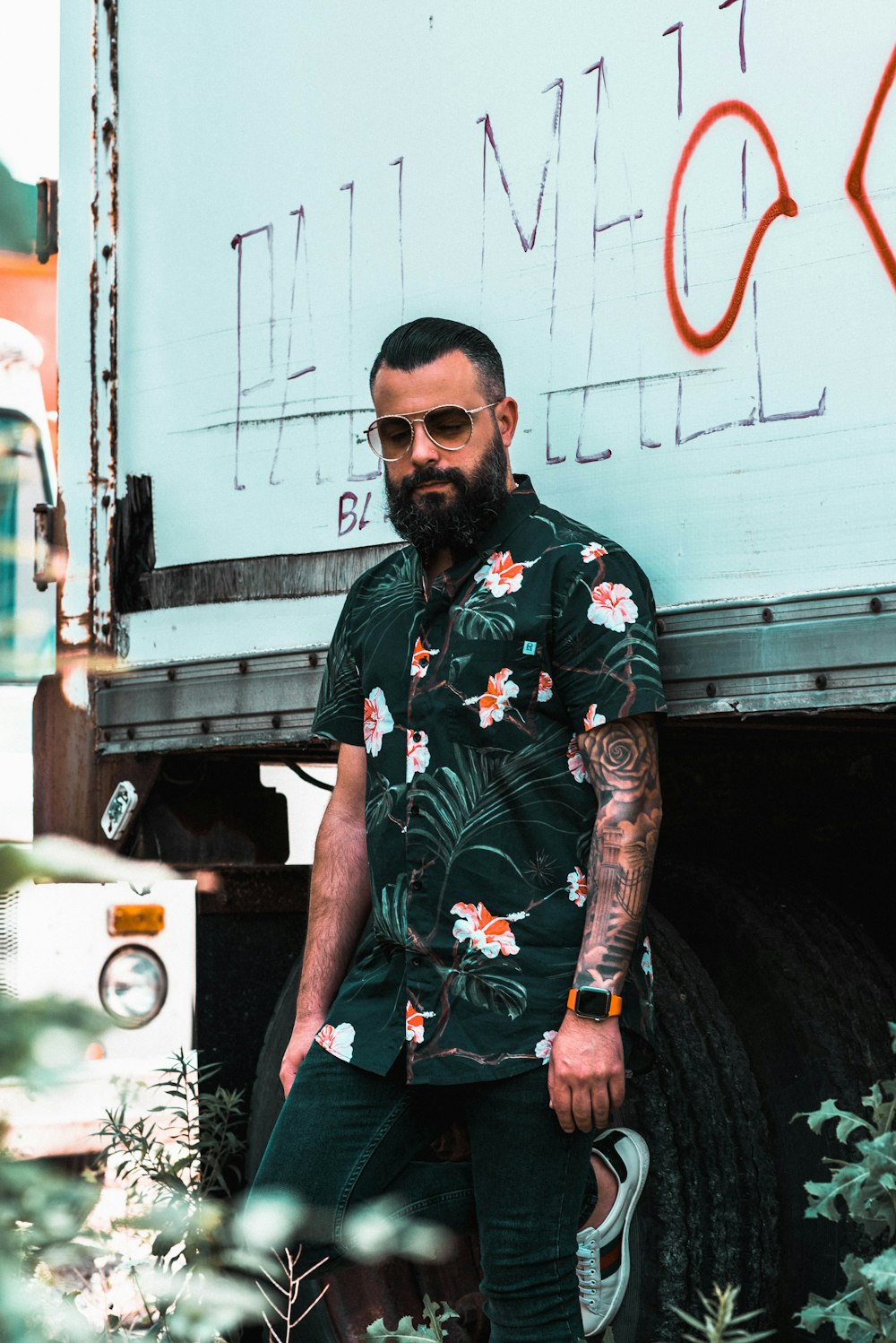 man wearing black floral button-up collared shirt