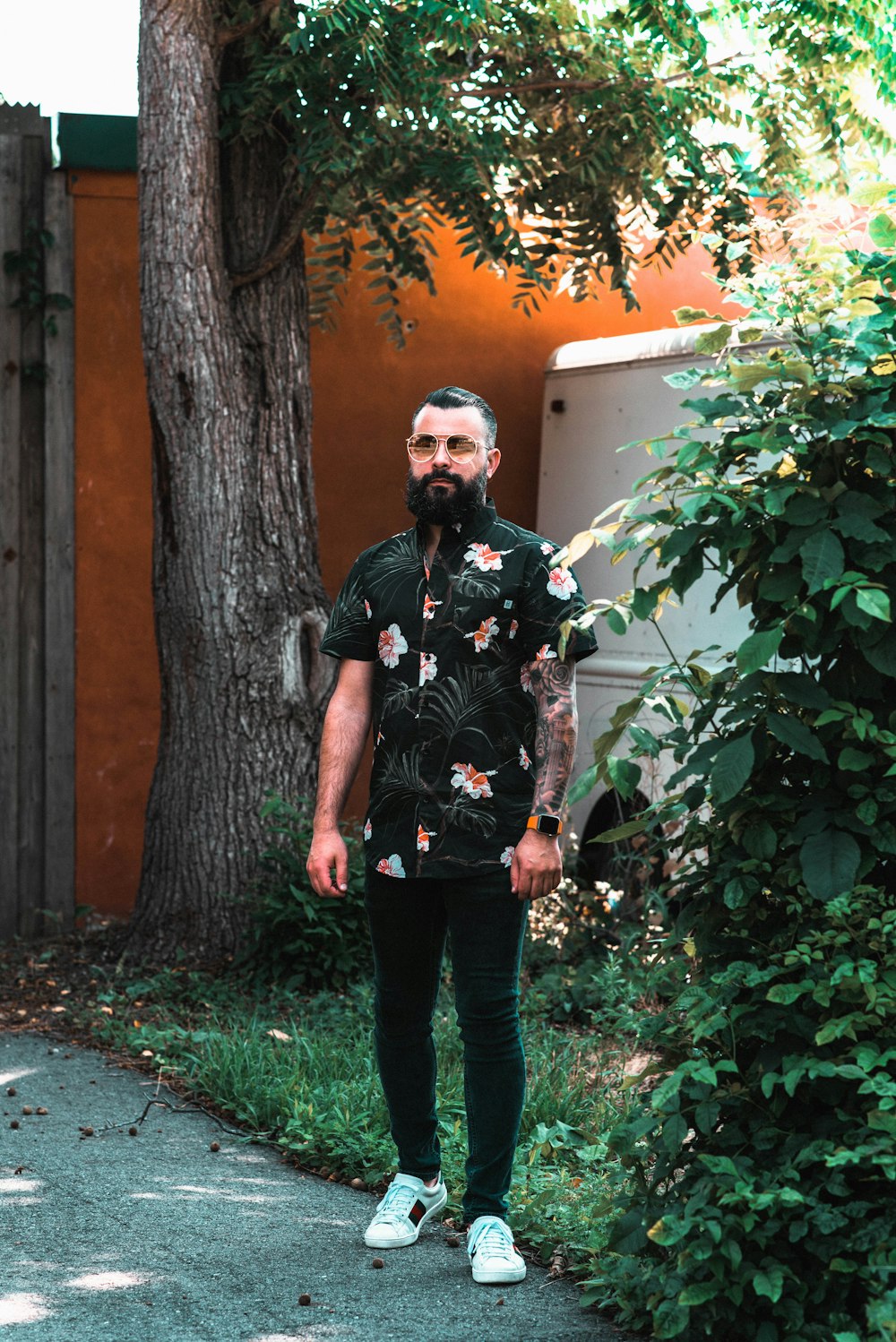 man standing beside tree