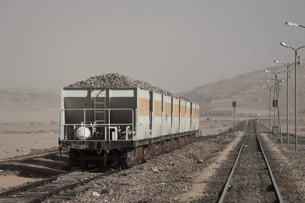 black and gray train carrying gravel