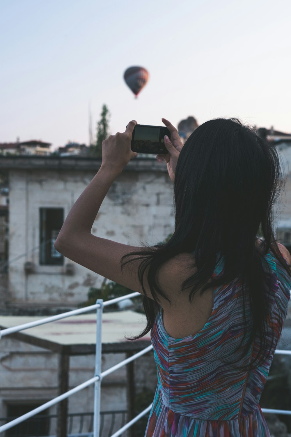 Femme debout et prenant une photo sur la montgolfière