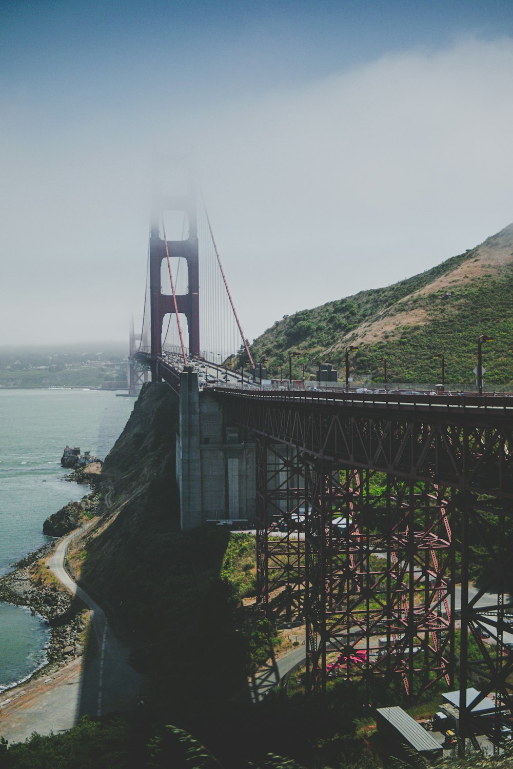 black and gray bridge beside body of water