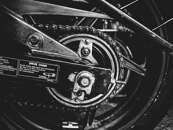 Shelf filled with various motorcycle chains and sprockets organized by size