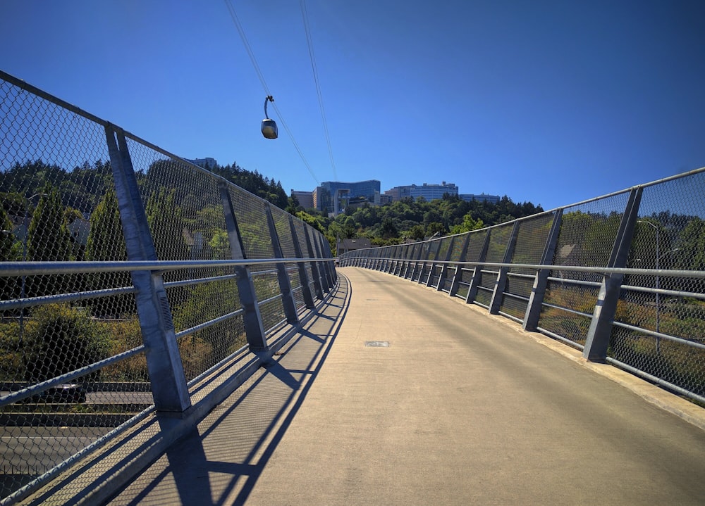 bridge and cable car under blue sky