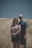 man and woman couple standing in brown grass trail