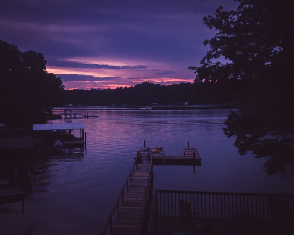purple sky over lake with wooden dusk at sunset
